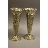 A PAIR OF SILVER TRUMPET VASES, having pierced and embossed scroll and floral decoration to