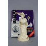 A CREAMWARE FIGURE, modelled as Emmeline Pankhurst, approximately 21.5cm high, together with