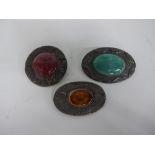 THREE RUSKIN POTTERY MOUNTED BEATEN WHITE METAL BROOCHES, oval turquoise cabochon 5.5cm x 4cm,