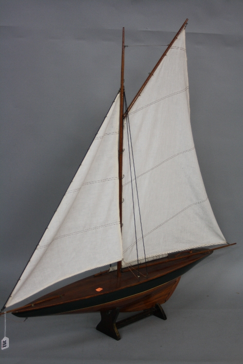 A PAIR OF WOODEN MODEL YACHTS ON STANDS, both with sails at full mast, approximate height 106cm x