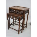 A NEST OF TWO 19TH CENTURY CHINESE HARDWOOD TABLES, the pierced frieze with foliate detail,