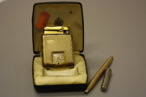 A CALIBRI 9CT GOLD AND GOLD PLATED MONOPOL CIGARETTE LIGHTER, fitted with a square dial clock,