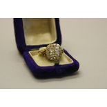 A LATE VICTORIAN DIAMOND CUSHION SHAPE CLUSTER RING, head measuring approximately 13.5mm in diameter