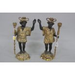 A PAIR OF SPELTER BLACKAMOOR FIGURAL CANDLESTICKS, modelled as Blackamoor with one hand raised and