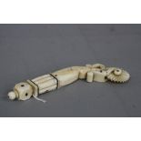 A 19TH CENTURY WALRUS TUSK PASTRY CRIMPER, carved with a sphere above a cube and columns atop a