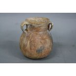 A RED TERRACOTTA TWIN HANDLED JAR, incised decoration to the outer border, from Palestine circa