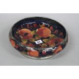 A MOORCROFT TUDRIC BOWL, the shallow circular bowl tube line decorated with pomegranate pattern, set