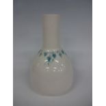 A RUSKIN POTTERY VASE, of bottle form having long neck to tapering body, green fruiting vine banding