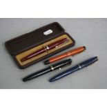 PARKER FOUNTAIN PENS, a Parker Duofold in burnt orange and black with gold coloured trim, a Parker