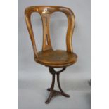 A LATE 19TH/EARLY 20TH CENTURY REVOLVING SHIPS CHAIR, with iron tripod base, 'R.M.S. Mauretania'