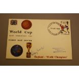 A 1966 WORLD CUP WINNERS FIRST DAY COVER, signed Bobby Moore