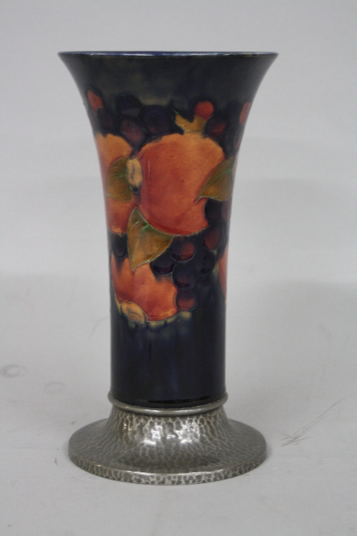 A WILLIAM MOORCROFT TUDRIC PEWTER BASED VASE, for Liberty & Co, Pomegranate design, having flared