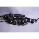 A CAMERA BAG CONTAINING A ZENIT 122 SLR CAMERA, a Photo Snipes 300mm, a Vivitar 80-200mm 1:4.5, a