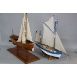TWO 20TH CENTURY WOODEN SCRATCH BUILT BOATS, comprising a dinghy on a wooden stand, height