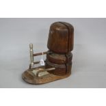 A TREEN MILLINERS HAT STAND, having corkscrew stretching/sizing mechanism with handle and head