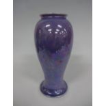 A RUSKIN POTTERY BALUSTER VASE, on circular foot with rolled rim in purple lustre glaze, impressed