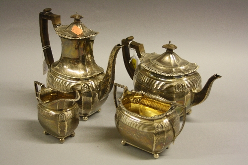 A SILVER FOUR PIECE TEA SERVICE, of shaped oval form with reeded banded top border with leafage