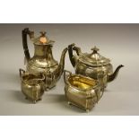 A SILVER FOUR PIECE TEA SERVICE, of shaped oval form with reeded banded top border with leafage