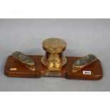 A LATE 20TH CENTURY NOVELTY TEAK AND BRASS DESK STAND, nautical themed with two removable rowing