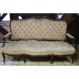A WALNUT FRAMED SETTEE, having serpentine front, carved floral and shell decoration to frame and top