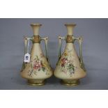 A PAIR OF ROYAL WORCESTER TWIN HANDLED CONICAL VASES, blush ivory ground with green detail,