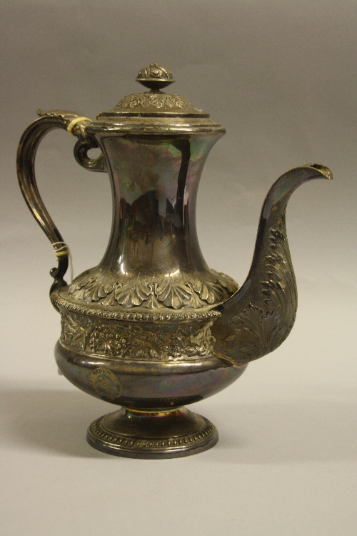 A SILVER COFFEE POT, of baluster form having relief acanthus leaves over central rope banding with