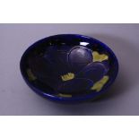 A MOORCROFT POTTERY FOOTED BOWL, Clematis pattern on blue ground, impressed marks to base,