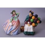 TWO ROYAL DOULTON FIGURES, 'Autumn Breezes', HN1911 and 'The Old Balloon Seller', HN1315 (2)