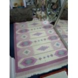 AN OATMEAL AND PINK GROUND RUG, approximate size 195cm x 140cm