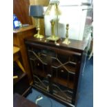 A MAHOGANY GLAZED TWO DOOR BOOKCASE, and three table lamps, (cables cut off table lamps) (4)