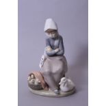 A LLADRO FIGURE GROUP, seated girl wrapped up against cold with mother duck and ducklings at feet