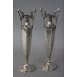A PAIR OF CONTINENTAL ART NOUVEAU WHITE METAL TWIN HANDLED VASES, the vases of hexagonal urn form