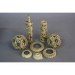 TWO LATE 19TH CENTURY CARVED IVORY PUZZLE BALLS, and parts of component stands (parcel)