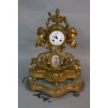 A MID 19TH CENTURY FRENCH GILT METAL MANTEL CLOCK, urn finial above the enamel dial with Roman and