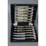 A CASED SET OF SIX ELIZABETH II VINERS LTD PISTOL HANDLED STEAK KNIVES AND FORKS, Sheffield 1957,