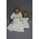 TWO ARMAND MARSEILLE BISQUE HEAD BABY DOLLS, first one nape of neck marked 'A.M. Germany' but