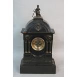 A LATE VICTORIAN BLACK SLATE MANTEL CLOCK, of architectural form, the domed top surmounted by a