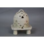 A BELLEEK FIRST PERIOD GRASS PATTERN HONEY POT AND COVER, in the form of a wicker skep on stand,