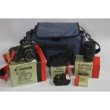 A BOXED CANON T50 SLR CAMERA, fitted with a 50mm 1:1.8 lens, also a camera bag holding a FD 28mm 1: