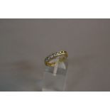 A LATE 20TH CENTURY 18CT GOLD SEVEN STONE DIAMOND HALF ETERNITY RING, diamonds channel set, total