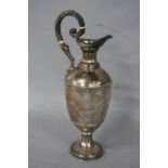 A VICTORIAN SILVER HOT WATER JUG, of ewer form, beaded rim, fluted neck, scrolled cast handle with