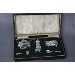 A GEORGE V CASED SILVER FIVE PIECE CRUET SET, of panelled oval outline, on four cabriole legs,