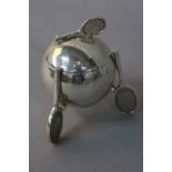 A GEORGE V SILVER TENNIS TROPHY WITH COVER, the trophy of ball form with a racquet finial, on