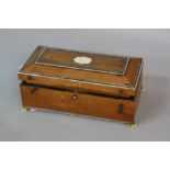 A 19TH CENTURY SANDALWOOD GAMES BOX, with ivory inlay to the hinged lid, on four ivory lion paw