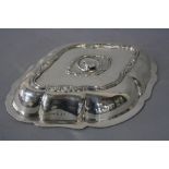 AN EDWARDIAN SILVER ENTREE DISH LID, of wavy oval outline, lacks handle, cast with foliate