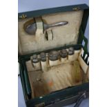 A GEORGE V HARRODS LTD GREEN LEATHER DRESSING CASE, peach silk liner (s.d.), incomplete contents,