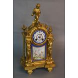 A MID 19TH CENTURY STYLE GILT METAL MANTEL CLOCK, putti surmounting an arched top with circular