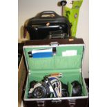 THREE CAMERAS CASES, including two Olympus OM10 SLR cameras with 50mm lenses, a 28mm lens, two