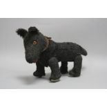 A BING 'TRIPPEL-TRAPPEL' PULL ALONG DOG ON WHEELS, early 20th Century, covered in black plush, black