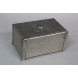 AN ARTS & CRAFTS PEWTER CASKET, hand hammered finish, inset with a Ruskin Pottery type mount to